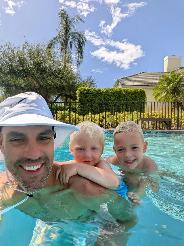 Jon Shilalis with his children in a swimming pool